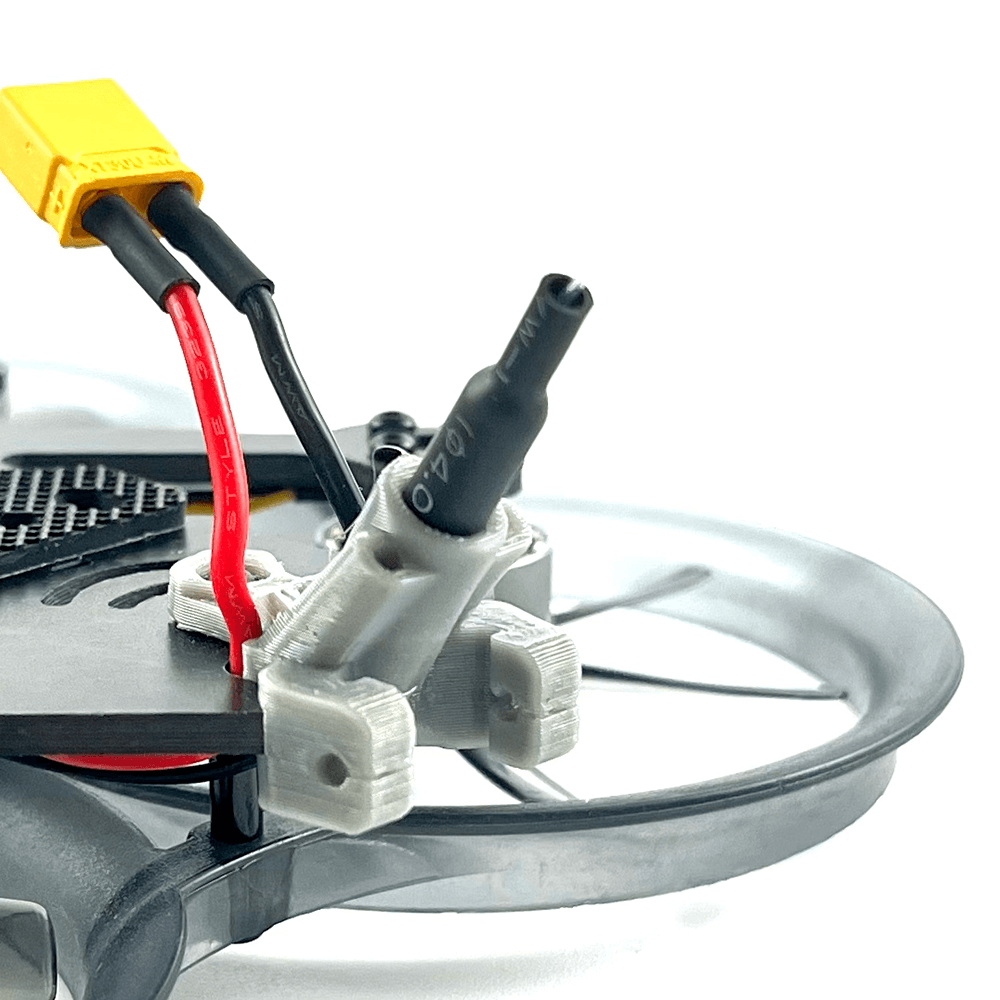 Close-up of the wiring and XT60 connector on an FPV drone, highlighting the attention to detail in assembly and the use of durable materials.