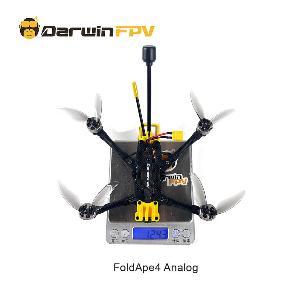 Top-down view of the DarwinFPV FoldApe4 Analog drone placed on a digital scale, displaying a total weight of 124.3 grams, with the quadcopter in a folded configuration.