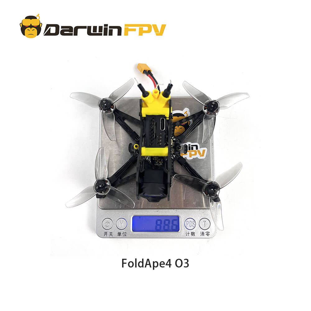 Top view of the DarwinFPV FoldApe4 O3 drone, showing the weight on a digital scale reading 88.6 grams. The drone is equipped with a yellow module and four propellers