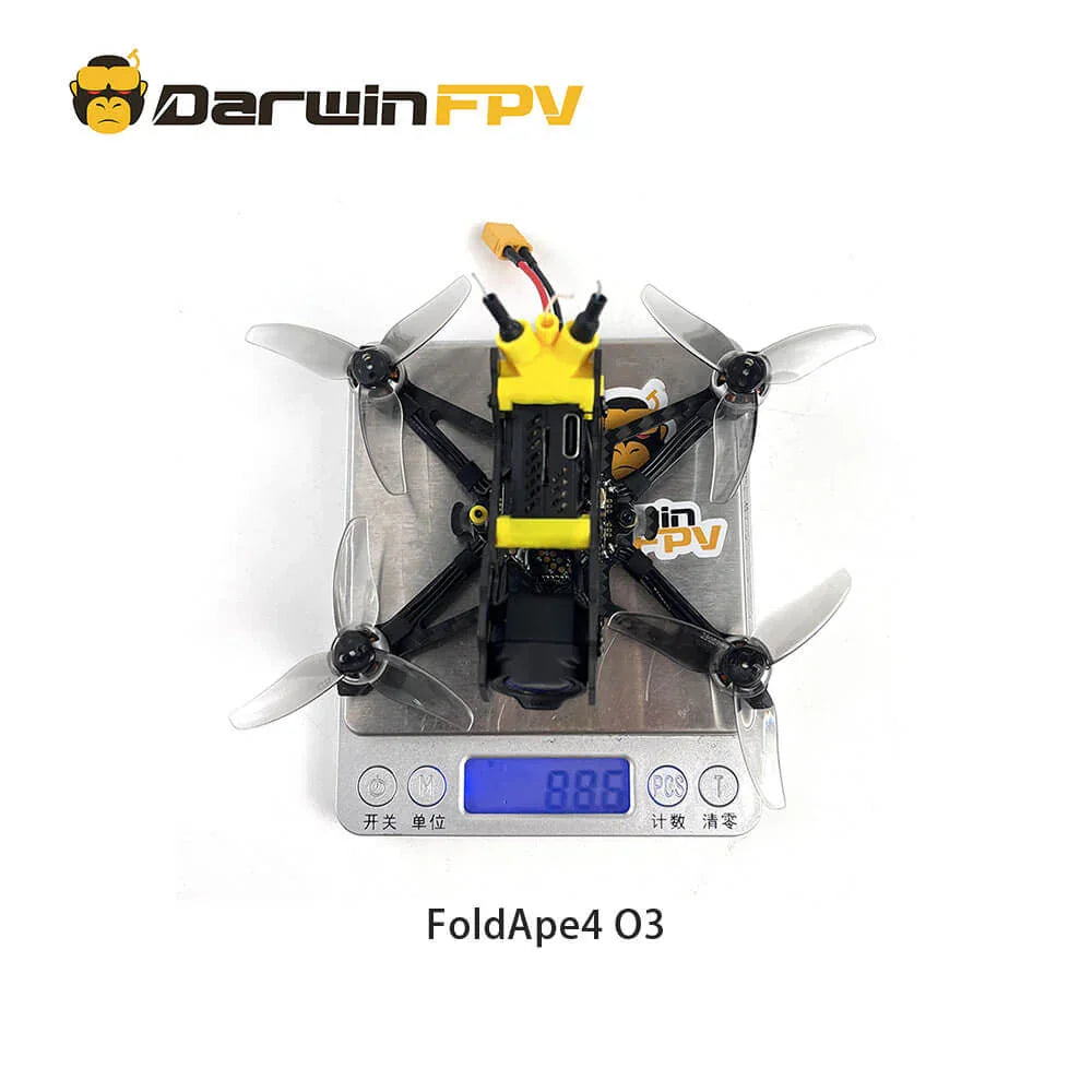 Top view of the DarwinFPV FoldApe4 O3 drone, showing the weight on a digital scale reading 88.6 grams. The drone is equipped with a yellow module and four propellers