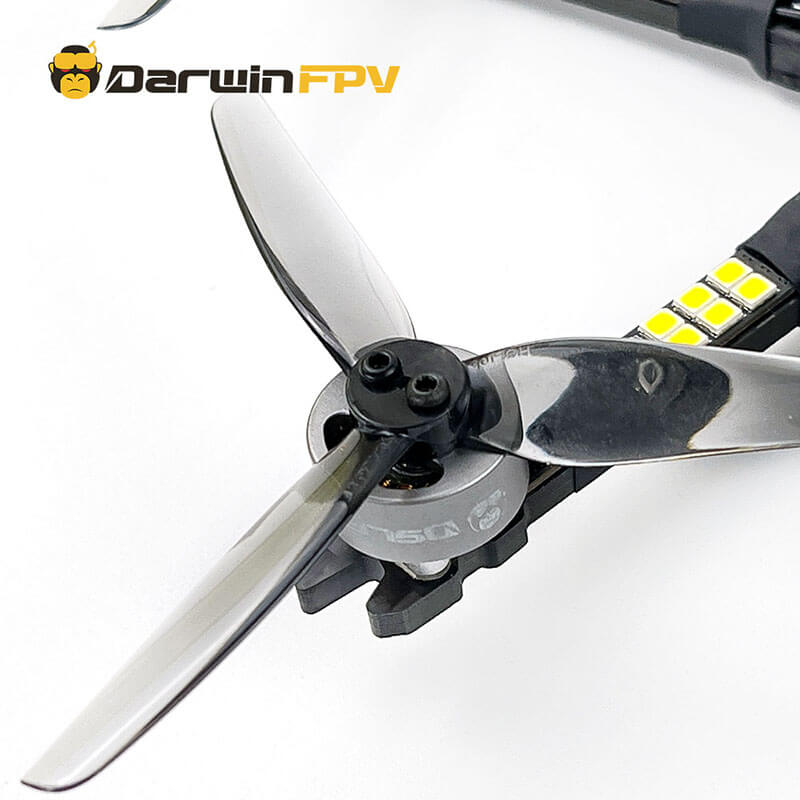 High-quality image showing the DarwinFPV drone's propeller and motor assembly, featuring carbon fiber blades and a sturdy motor setup