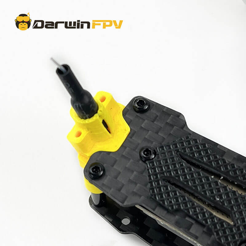 Close-up of DarwinFPV drone's antenna mounted on a durable carbon fiber frame with yellow 3D printed holder