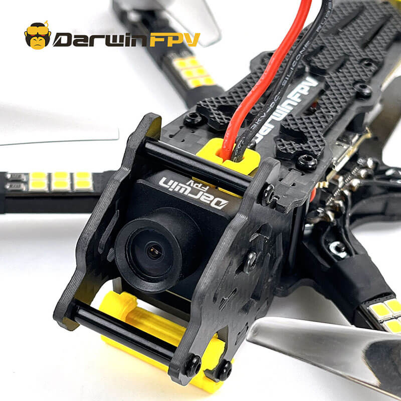 Close-up detail of DarwinFPV drone's front camera mount and wiring on a carbon fiber frame