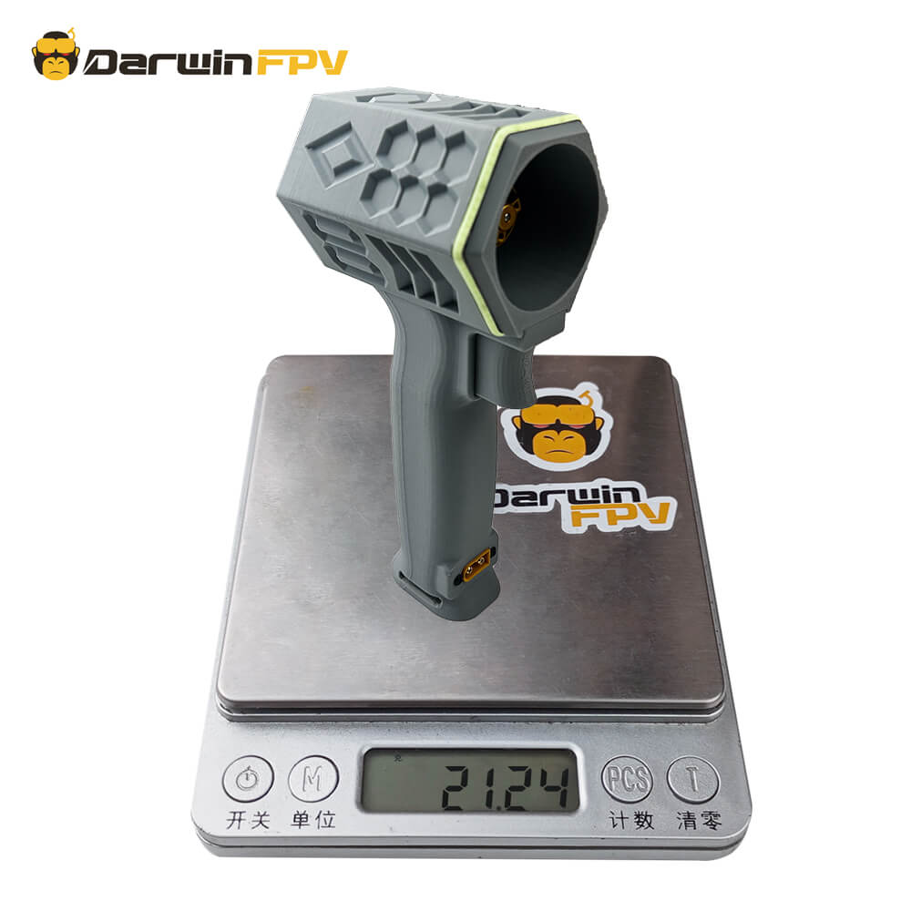 The DarwinFPV violent fan is placed on an electronic scale for weight measurement. The fan is gray with a brand logo at the bottom, and the screen of the electronic scale shows the number 2124.