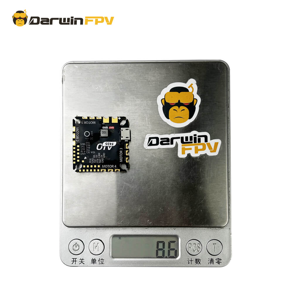 The DarwinFPV F435 AIO  is being weighed on a digital scale with the brand's logo visible