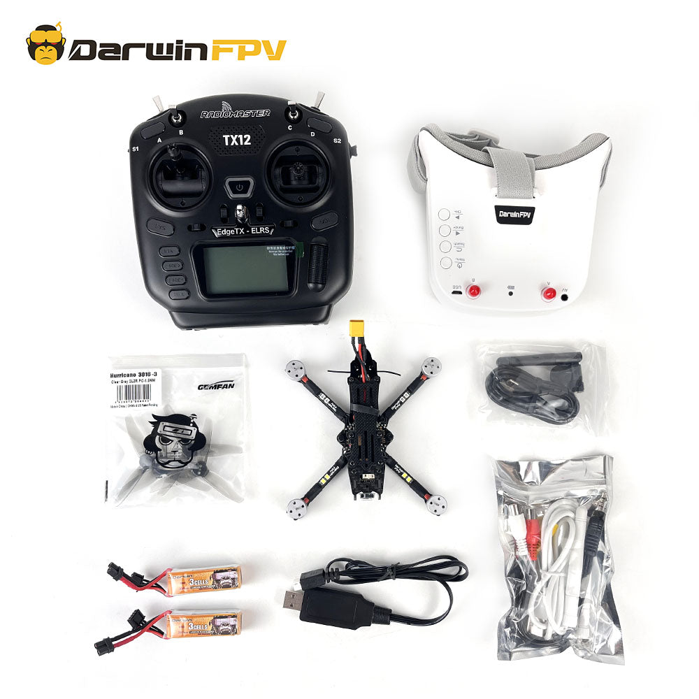 Complete DarwinFPV BabyApe 3 Drone Kit including drone, remote controller, FPV goggles, spare propellers, batteries, charger, and accessories, displayed with all components neatly arranged